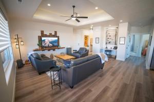 a living room with two couches and a table at Searchers Hideaway at Kabab - New West Properties in Kanab