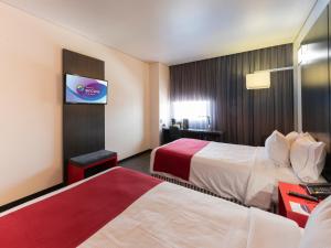Postel nebo postele na pokoji v ubytování Ramada Encore by Wyndham Puebla