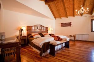 a bedroom with a large bed and a desk at Hotel Marqués De Tojo in Purmamarca