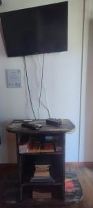 a table with a television on top of it at Cabaña Pelulandia in Playa Verde +6 photos