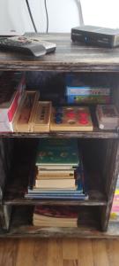 a stack of books sitting on a shelf at Cabaña Pelulandia in Playa Verde