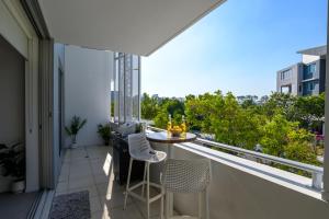 a balcony with a table and chairs on a balcony at Luxury Stays Varsity-Robina-Bond in Gold Coast
