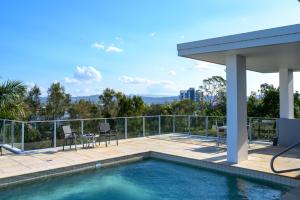 a house with a swimming pool and a patio at Luxury Stays Varsity-Robina-Bond in Gold Coast