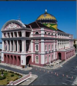 a large pink building with a dome on top of it at Modelo flat apartamento 603 in Manaus