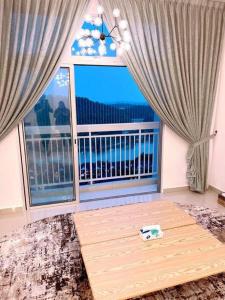 a room with a large window with a view of the ocean at The Halt Putrajaya in Putrajaya