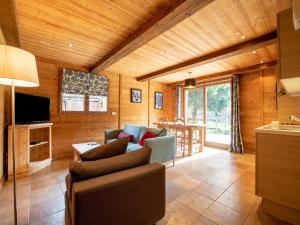 a living room with a couch and a tv and a table at Cosy apartment in Tignes with garden in Tignes