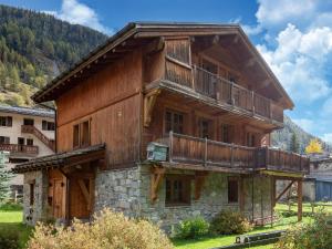 a large wooden building with a balcony on it at Cosy apartment in Tignes with garden in Tignes