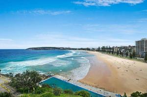 a view of a beach with people in the water at WOW - King Beds, Huge Yard, New Reno, close to Beach, Private, Level no stairs in Sydney