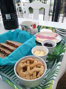 a table topped with different types of bread and pretzels at Central y Tranquilo alojamiento in Villa Alemana +7 photos