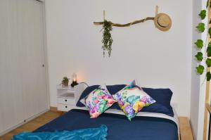 a bedroom with a bed with pillows on it at Loft Paraiso Vintage in Bogotá