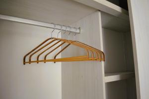 a closet with a wooden hanger in a room at Loft Paraiso Vintage in Bogotá