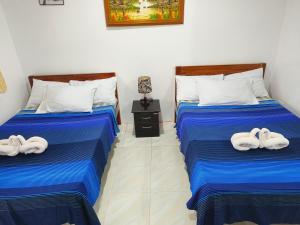 a room with two beds with towels on them at Hadefe Resort in El Nido