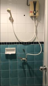 a shower in a bathroom with a phone on the wall at Pattaya inn By Thai Smile in Pattaya Central