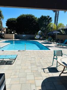 a swimming pool with a table and a chair at Beach Shack in Huntington Beach