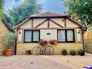 una bicicletta parcheggiata di fronte a una casa di The Cosy Cottage, Old Soles bridge Lane a Chorleywood