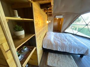 a bedroom in a tiny house at Alma Andina in Puelo