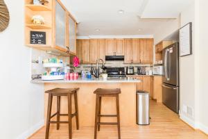 a kitchen with wooden cabinets and stainless steel appliances at Beautiful House 9 Beds King Bed 3 Baths Family Friendly in Arlington