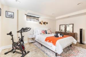 a bedroom with a bed and a treadmill at Beautiful House 9 Beds King Bed 3 Baths Family Friendly in Arlington