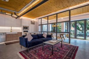 a living room with a blue couch and a table at Halifax Rooftop Ground Level in Halifax