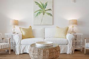 a living room with a white couch and a table at Sand Buckets Unit C, Ocean View Beach Townhouse in Mexico Beach