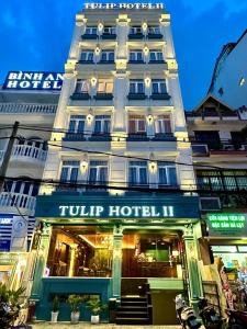 a hotel building with a sign that reads tour hotel at Tulip Hotel 2 in Da Lat