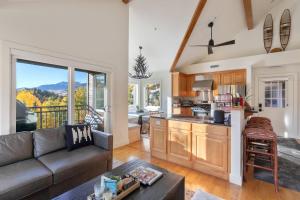 a living room with a couch and a kitchen at Outlaws Creek in Telluride