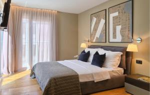 a bedroom with a large bed with blue pillows at Villa Oliva 1 in Umag