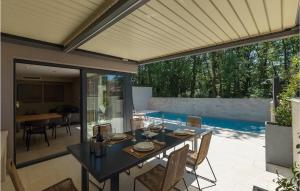 a patio with a table and chairs and a pool at Villa Oliva 1 in Umag