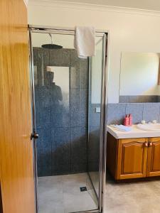 a shower with a glass door in a bathroom at Tee Off Milura in Mildura