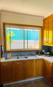 a kitchen with a sink and a window at Tee Off Milura in Mildura