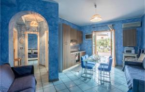 een keuken en een woonkamer met blauwe muren bij 2 Bedroom Amazing Apartment In Giardini Naxos in Giardini Naxos