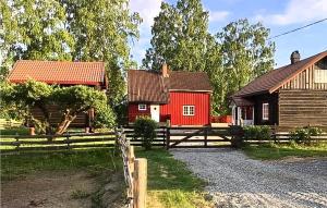 a red house and a barn with a fence at 1 Bedroom Beautiful Home In Vormsund in Vormsund