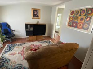 a living room with a couch and a television at Two bedroom, living/dining room in Bellport