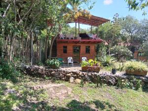 a tree house with a porch and a deck at La Troje Cabañas in Tepoztlán