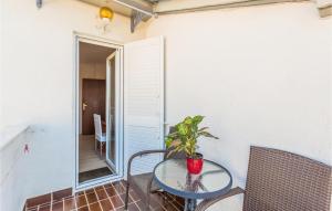 a small table on a balcony with a potted plant at Stunning Home In Porec With Wifi in Poreč