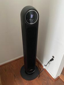 a black radiator is plugged into a wall at Two bedroom, living/dining room in Bellport +36 photos