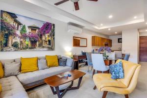 a living room with a couch and a table at A FEW BREEZY STEPS TO THE BEACH ~LUXURIOUS STAY~ in Puerto Vallarta