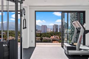 a gym with a view of a city at A FEW BREEZY STEPS TO THE BEACH ~LUXURIOUS STAY~ in Puerto Vallarta