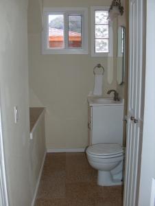 uma casa de banho com um WC, um lavatório e uma janela em Moana Hale Nui em Hauula