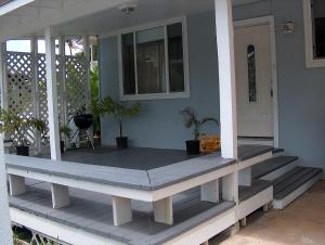 a porch of a house with stairs and plants at Moana Hale Nui in Hauula