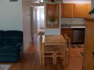 a kitchen and living room with a table and a couch at Moana Hale Nui in Hauula