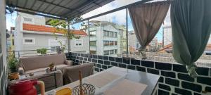 a balcony with chairs and a view of a city at In The Heart Of Praia - Family B&B in Praia
