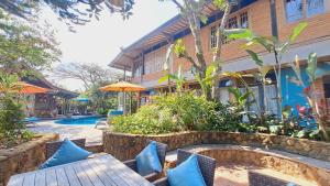 a resort with blue pillows sitting next to a building at Ayu Dira Heritage House in Ubud