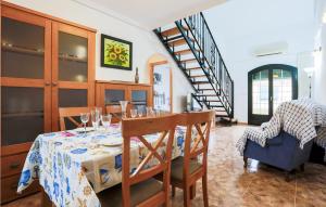 a dining room with a table and a staircase at 3 Bedroom Lovely Apartment In Los Alczares in Los Alcázares