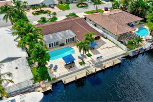 an aerial view of a house with a dock at Riviera - Canal Views, Pool, & Work Friendly. in Fort Lauderdale