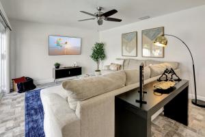 a living room with a couch and a table at Riviera - Canal Views, Pool, & Work Friendly. in Fort Lauderdale