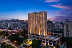 a tall building with a sign on top of it at Crowne Plaza Shanghai Jinxiu, an IHG Hotel in Shanghai