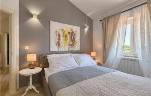 a bedroom with a bed and a table and a window at Villa Piccolo Paradiso in Rovinj
