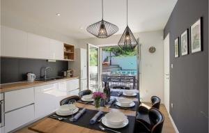 a kitchen with a table and chairs and a kitchen with a view at Villa Karmen Adriatica in Zadar