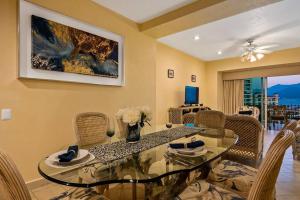 a dining room with a glass table and chairs at Beach Front-Ocean Views-Marina Luxury Condo-BVG in Puerto Vallarta